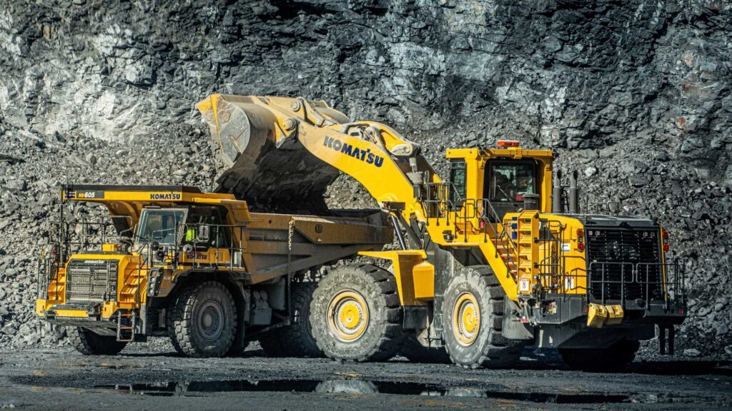 Wheel loader loading crushed stone into a haul truck at a NESL quarry